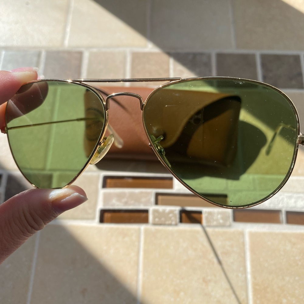 Ray-Ban RB3025 Aviator Large Metal Sunglasses with Gold Frame and green lens.